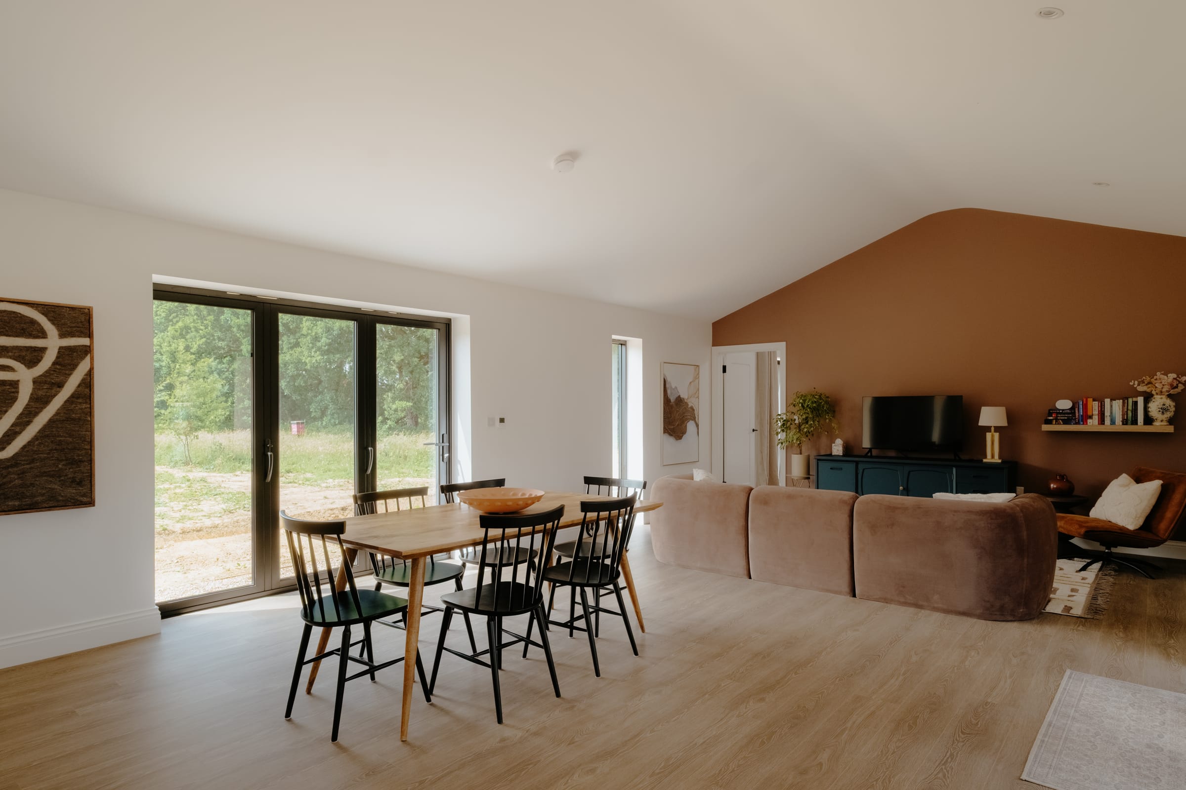 The Barn — dining and living area with bifold doors