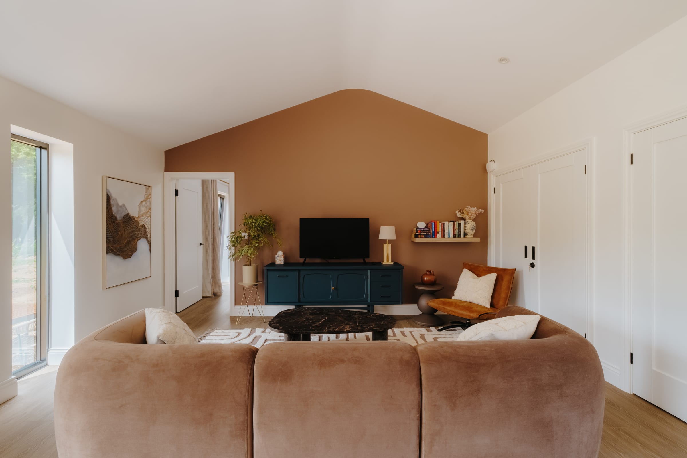 The Barn — open-plan living room with vaulted ceiling